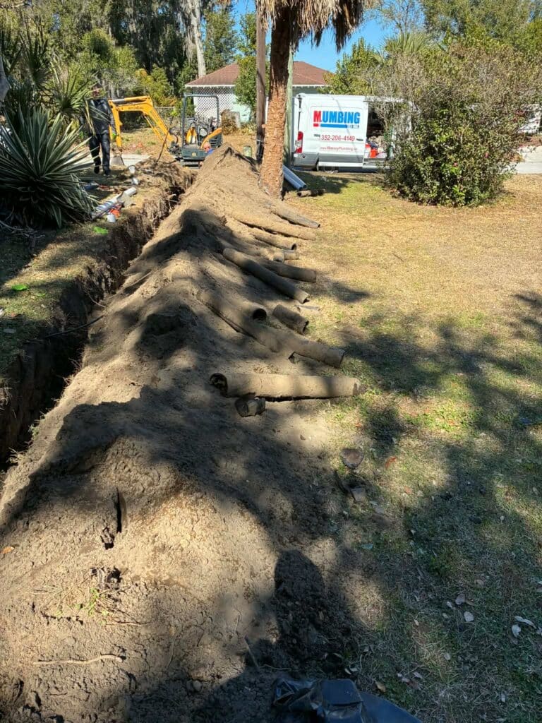 Sewer line replacement excavation with old clay pipes removed by Massey Plumbing in Dade City, FL